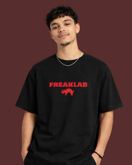 Person wearing a black t-shirt with 'FREAKLAB' printed in red on a yellow background